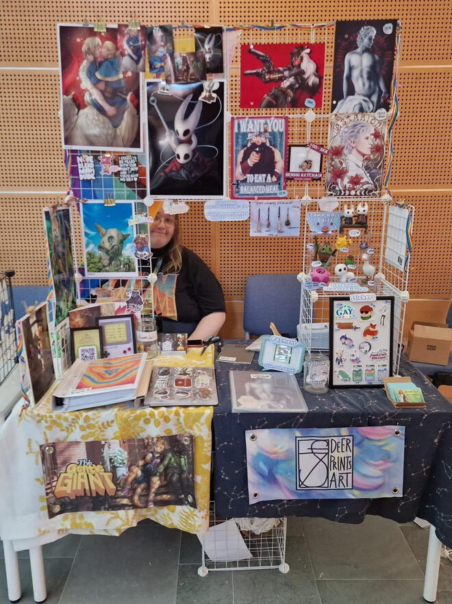 the artist alley table of the gentle giant & deerprints art during Närcon summer 2024